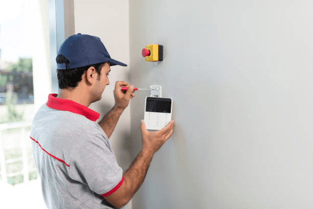 Home alarm and camera hardware on a residential exterior