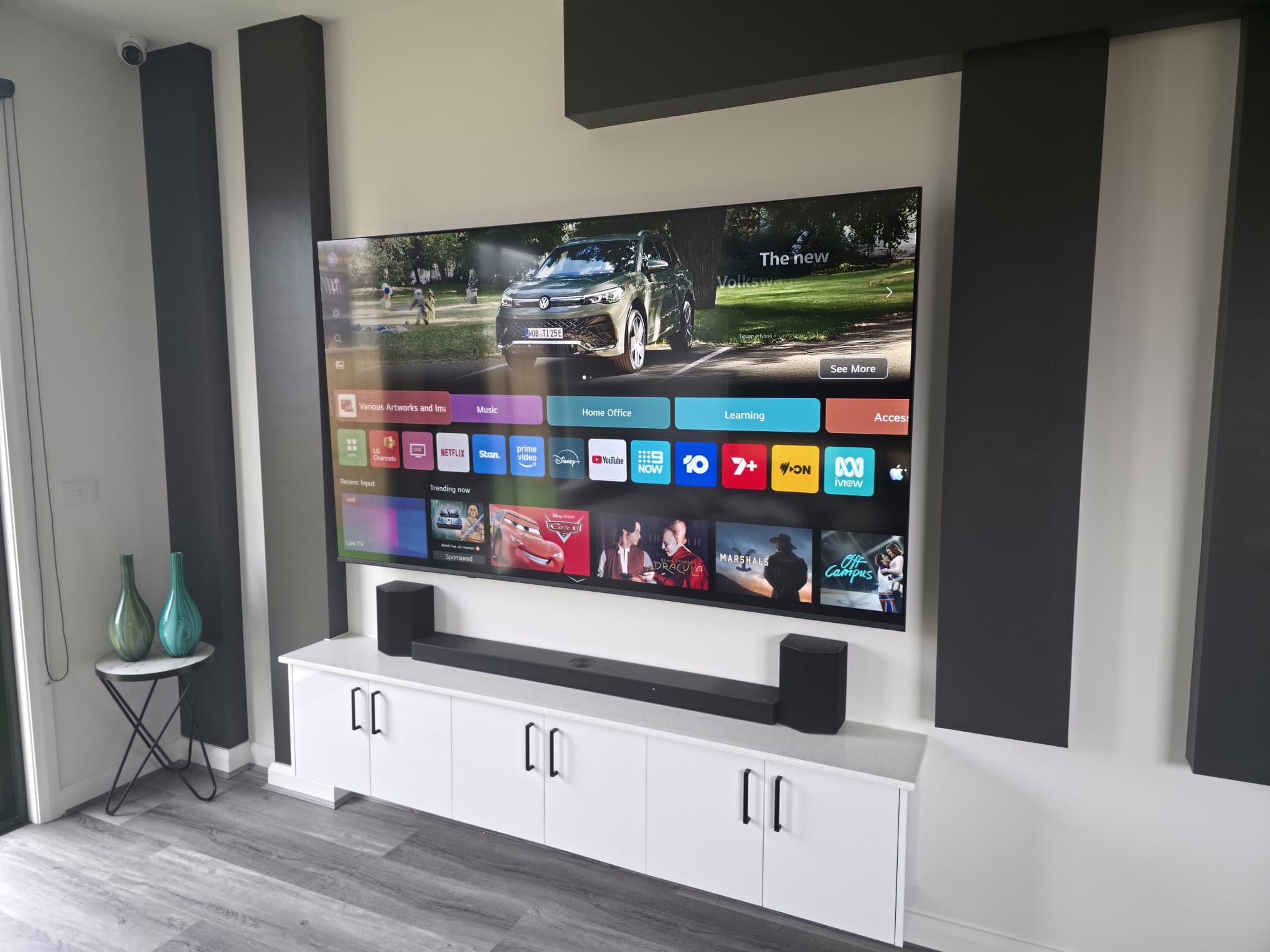 Living room entertainment setup with a ceiling CCTV dome camera