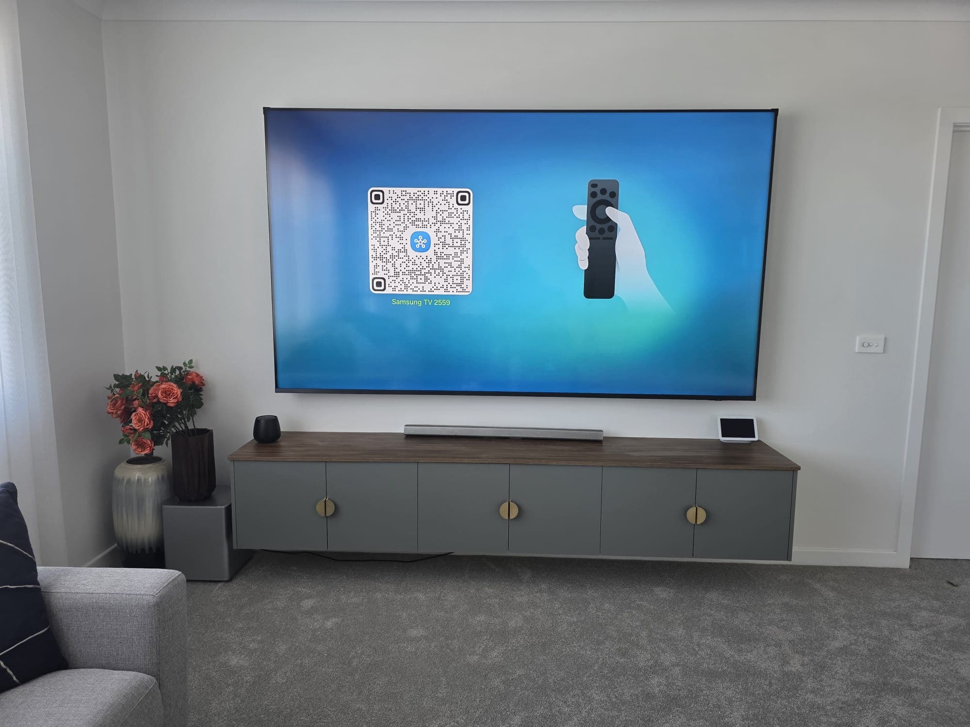 Samsung TV with floating console and subwoofer