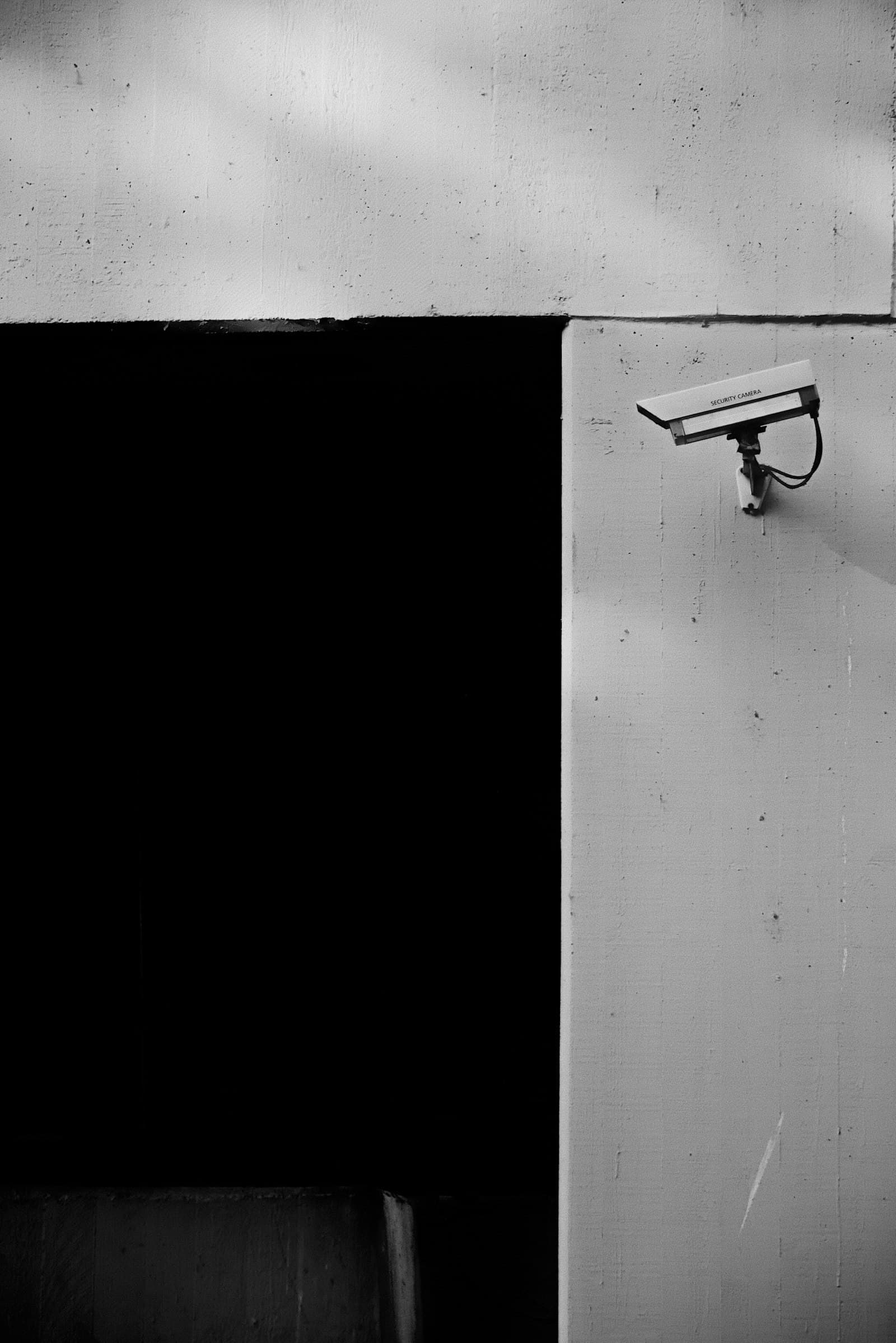 Wall-mounted security cameras on a clean exterior corner