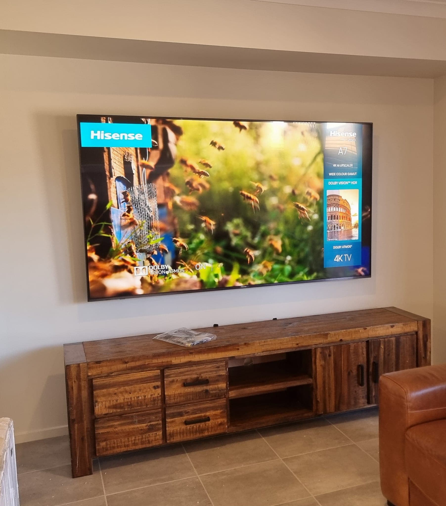 Hisense TV above a rustic timber console