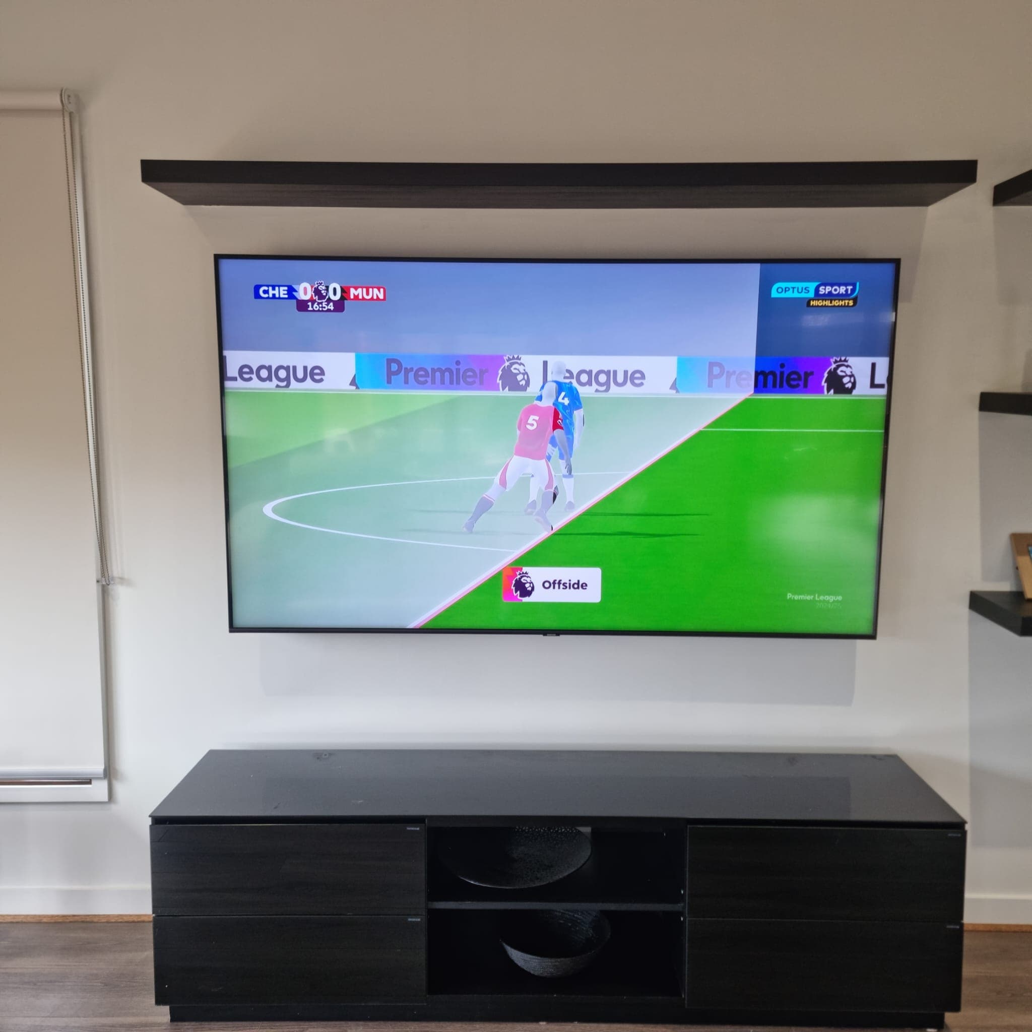 Square-format TV install showing Optus Sport