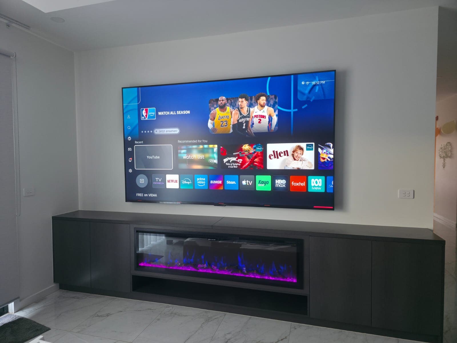 VIDAA smart TV above an electric fireplace