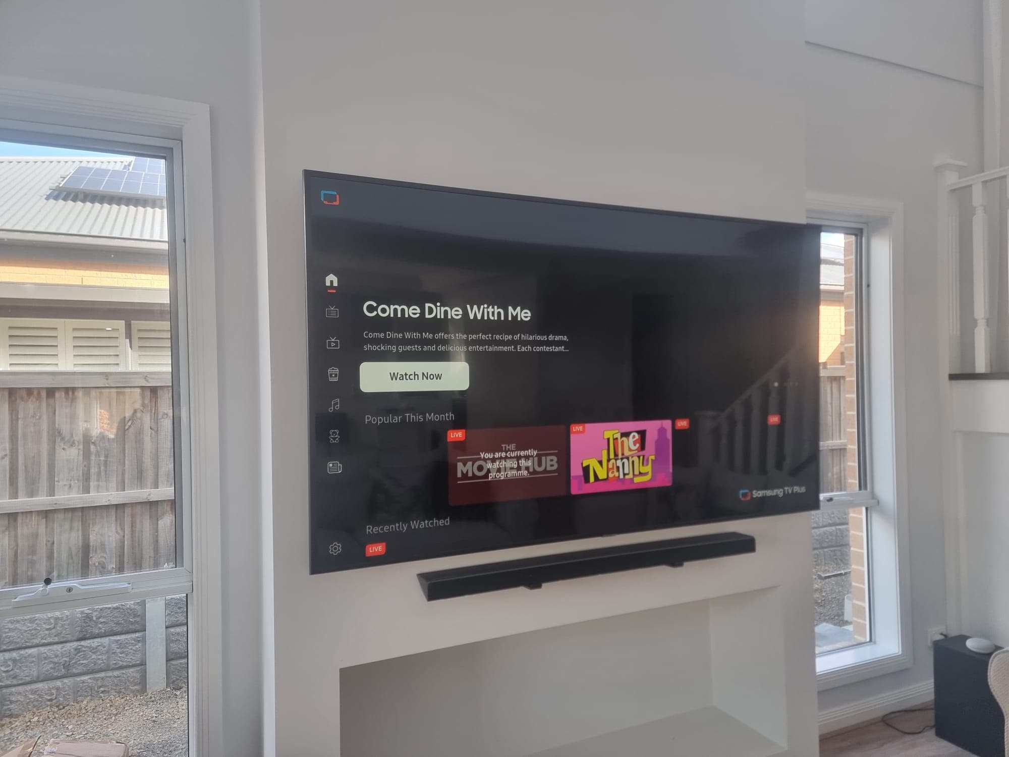 Samsung TV between windows with soundbar