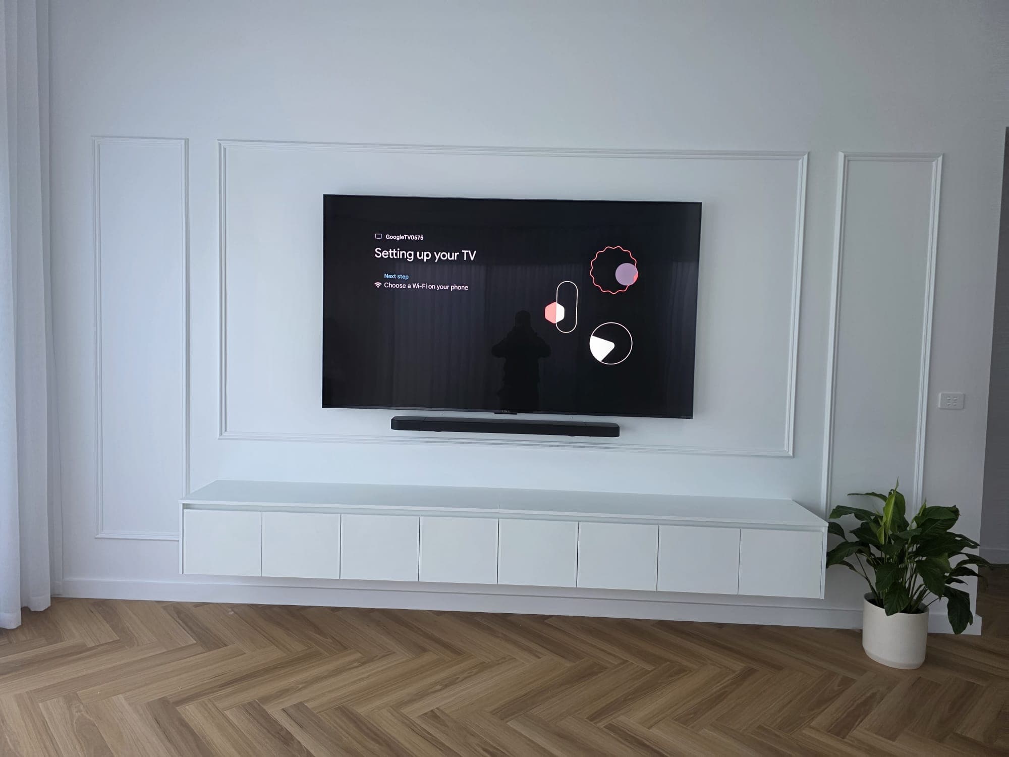 Google TV mounted above wainscoting with soundbar